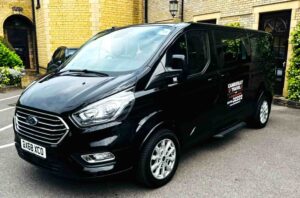 camberley taxis van standing front of building